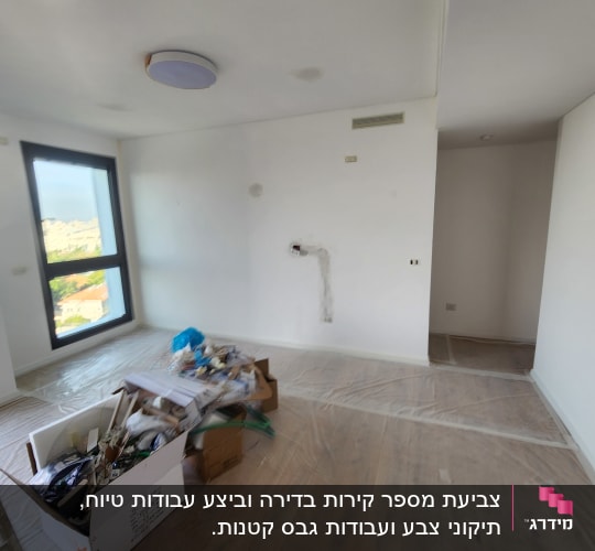 חדר עם קופסאות כלים לצביעה על הרצפה